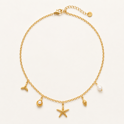 Collier Bora Bora Merveilleuse Bijoux, chaîne fine dorée breloques marines étoile de mer queue de baleine coquillage perle baroque